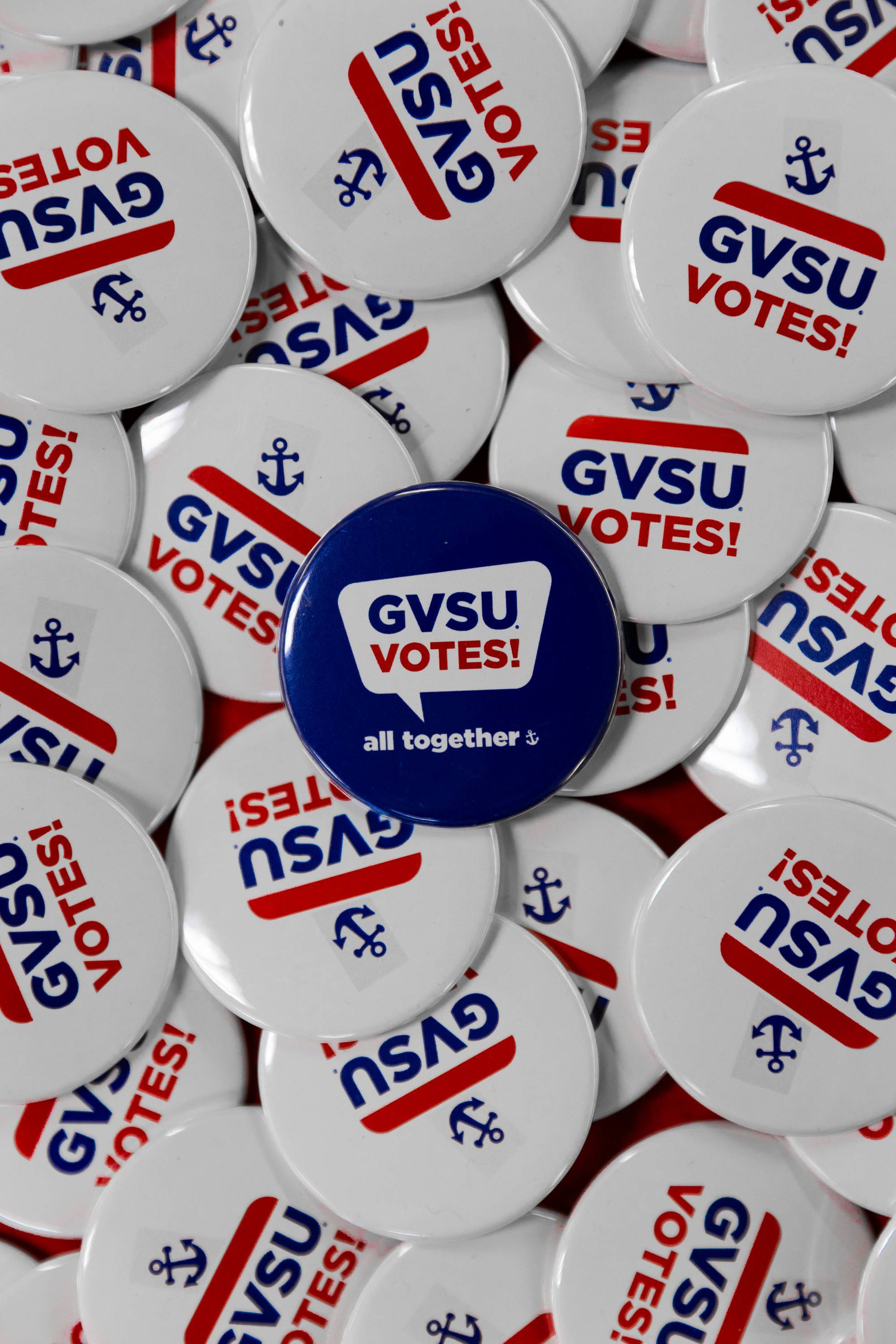 A pile of "GVSU Votes!" button pins